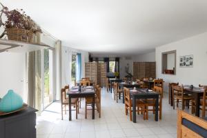 a dining room with tables and chairs in a restaurant at Domaine Bocca di Feno in Bonifacio