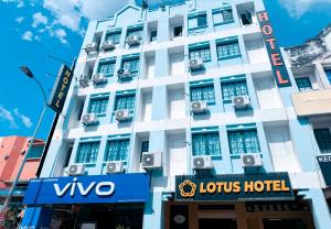 a white building with a hotel sign in front of it at Sun Inns Seremban Formerly known as Lotus Seremban in Seremban