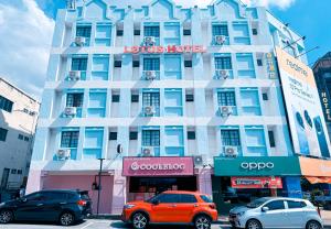 a building with cars parked in front of it at Sun Inns Seremban Formerly known as Lotus Seremban in Seremban