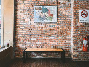 a brick wall with a bench against a brick wall at Sun Inns Seremban Formerly known as Lotus Seremban in Seremban