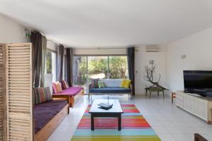 a living room with a couch and a table at Domaine Bocca di Feno in Bonifacio