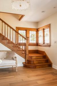 a living room with wooden stairs and a couch at The Hen Houses in Wildwood