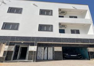 a building with a car parked in front of it at Luxury Qurtuba in Nouakchott