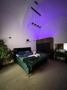 una camera da letto con letto e illuminazione viola di SPAYA JACUZZI centrum apartment - with home cinema & private parking a Košice