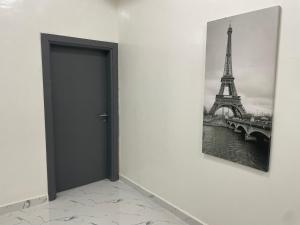 a door in a room with a picture of the eiffel tower at Luxury Qurtuba in Nouakchott