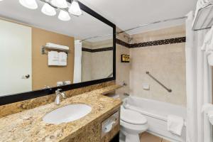 a bathroom with a sink and a toilet and a tub at Best Western PLUS Inner Harbour Hotel in Victoria