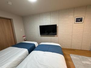 เตียงในห้องที่ Comfy House Namba