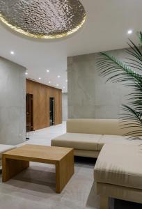 a living room with a couch and a coffee table at Rahat Palace Hotel in Almaty