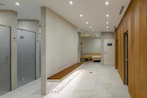 a corridor of an office with a bench in a hallway at Rahat Palace Hotel in Almaty