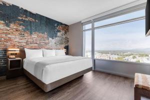 A bed or beds in a room at Cambria Hotel Downtown Asheville