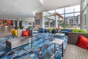 um átrio com sofás, mesas e janelas em Cambria Hotel Nashville Airport em Nashville