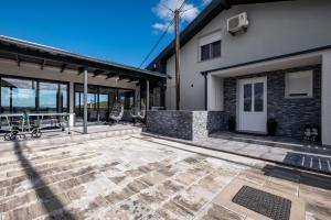 a patio of a home with glass doors at Relax house MAROKIS in Karlovac