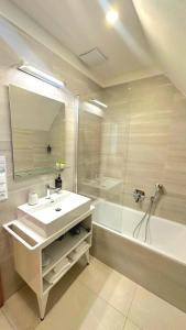 a bathroom with a sink and a shower and a tub at Hotel Karlova Prague in Prague