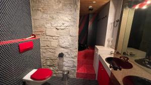 a bathroom with a red toilet and a sink at Lakeside-Apartment-2 Appartement avec une grande terrasse et vue panoramique sur le lac in Vevey