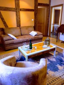 a living room with a couch and a coffee table at Maison Rebleuthof Sauna & Fitness in Riquewihr