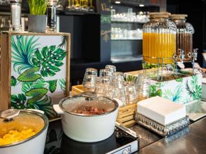 a buffet with drinks and other items on a table at ibis Bordeaux Pessac Route des Vins in Pessac