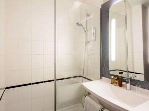 a bathroom with a shower and a sink at ibis Bordeaux Pessac Route des Vins in Pessac