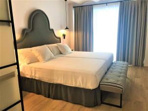 Katil atau katil-katil dalam bilik di Suites Hom Sevilla