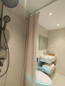 a bathroom with a shower curtain and a sink at Flower Whisperer Homestay in Zhangjiajie