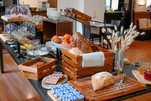 a buffet with bread and other foods on a table at Hotel International & Terminus in Geneva