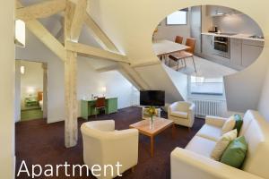 an open living room with white furniture and a kitchen at Hotel International & Terminus in Geneva