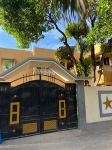 a building with a black garage door with a star on it at Zuri home in Watamu