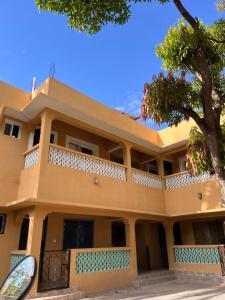 a building with a tree in front of it at Zuri home in Watamu