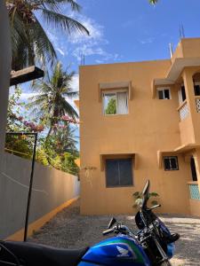 a motorcycle parked in front of a building at Zuri home in Watamu