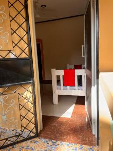 a room with a table with a red cloth on it at Zuri home in Watamu