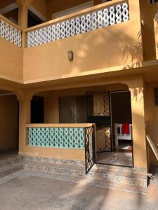 a house with a gate in the courtyard at Zuri home in Watamu