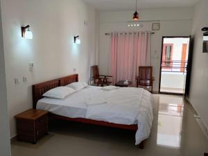 Katil atau katil-katil dalam bilik di CHAEL Airport Residency,Nedumbassery Cochin