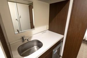 a bathroom with a sink and a mirror at Hotel Alpha Inn Akita - Vacation STAY 67295v in Akita