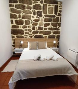 A bed or beds in a room at Recanto da Neta