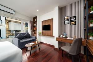 a living room with a couch and a chair at Charlie House Hanoi in Hanoi