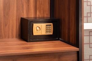 a microwave oven sitting on top of a wooden shelf at Charlie House Hanoi in Hanoi