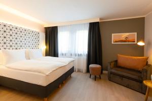 Garner Hotel Mannheim City by IHG tesisinde bir odada yatak veya yataklar