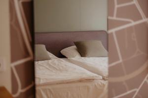 a reflection of a bed with pillows in a mirror at Hotel-Restaurant Haselhoff in Coesfeld