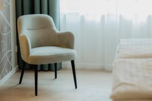 a chair sitting in a room next to a window at Hotel-Restaurant Haselhoff in Coesfeld