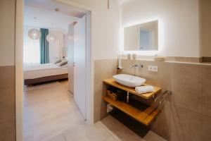 a bathroom with a sink and a bed at Hotel-Restaurant Haselhoff in Coesfeld