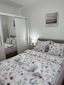 a bedroom with a bed with towels on it at Apartment Athens in Sombor