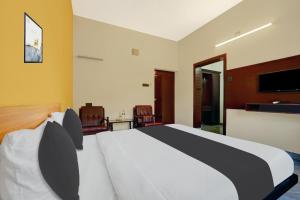 Ένα ή περισσότερα κρεβάτια σε δωμάτιο στο Super Hotel O Thrissur Near Thrissur Medical College