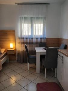 Cette chambre comprend une table, des chaises et un lit. dans l'établissement Studio Sokak centar, à Sokobanja