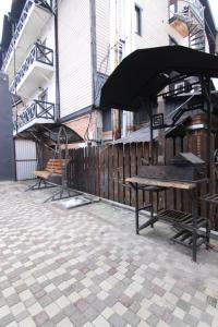 a bench sitting on a patio next to a building at Proskurov Holiday Home in Bukovel