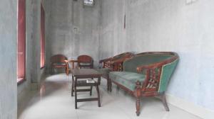 a group of chairs and a table in a room at Avicenna Hotel in Palangkaraya