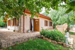 uma pequena casa com uma porta num quintal em Agri Resort San Giuliano em Santa Maria la Palma