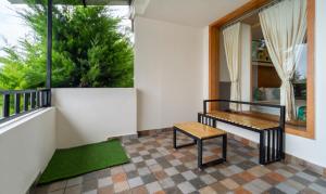 a porch with a bench and a window at Treebo Tranquil Heights in Kodaikānāl