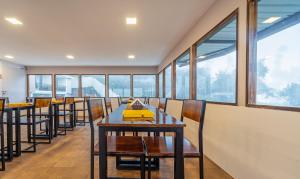 a dining room with a long table and chairs at Treebo Tranquil Heights in Kodaikānāl