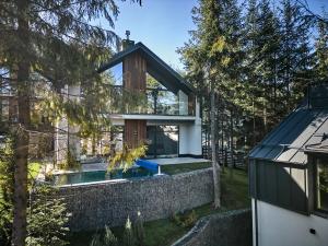 a house with a swimming pool and a brick wall at Buko Village by Fomich in Bukovel