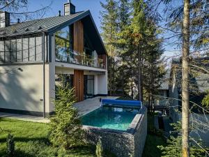 a house with a swimming pool in the yard at Buko Village by Fomich in Bukovel