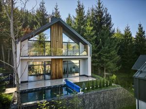 a house with a pool in front of it at Buko Village by Fomich in Bukovel